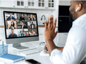 man-waiving-at-computer