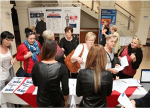 people-standing-around-information-table
