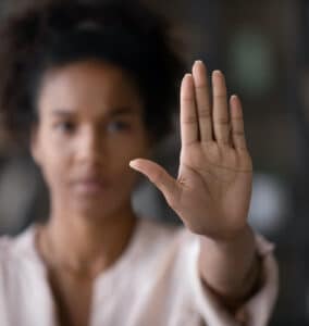 woman-holding-hand-up-in-stop-gesture