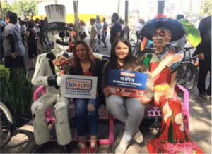 women-sitting-with-skeleton-statues